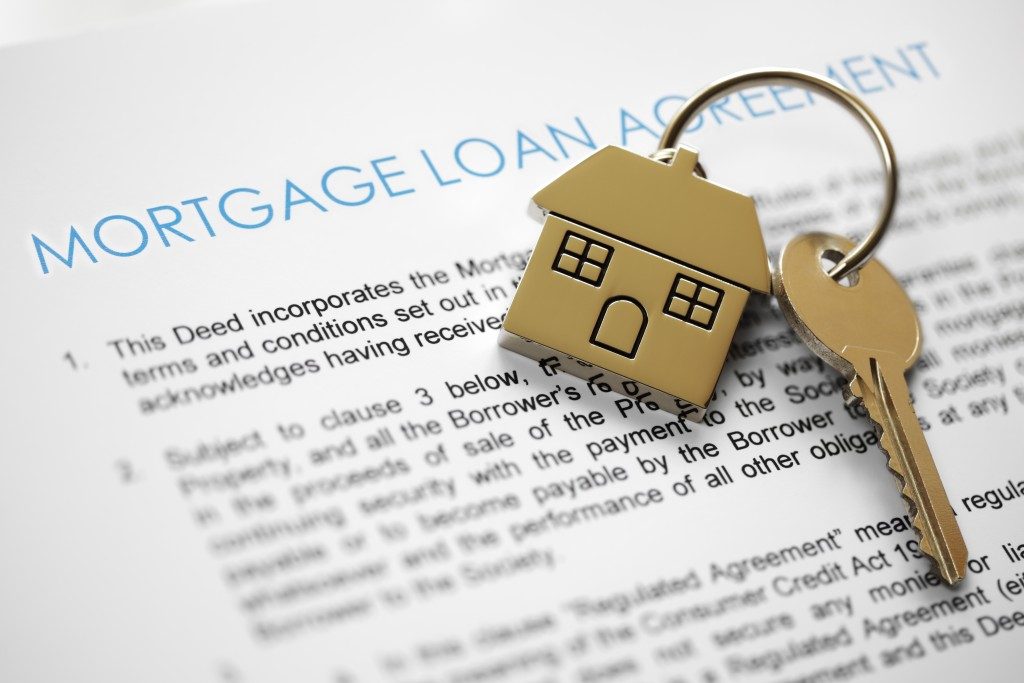 Mortgage loan agreement application with house-shaped key