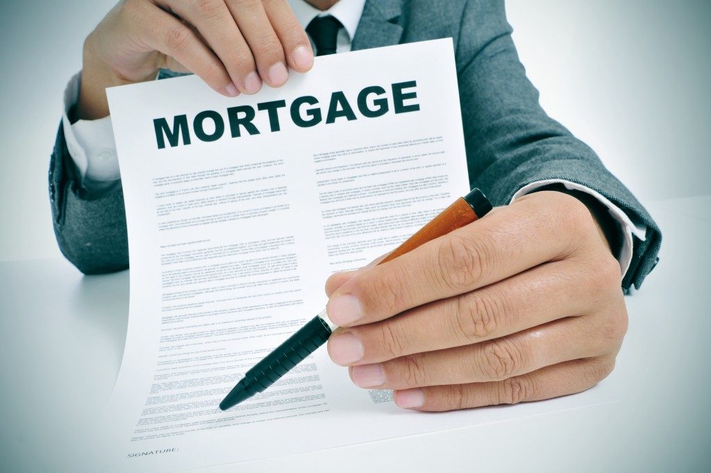 Man holding out a mortgage contract