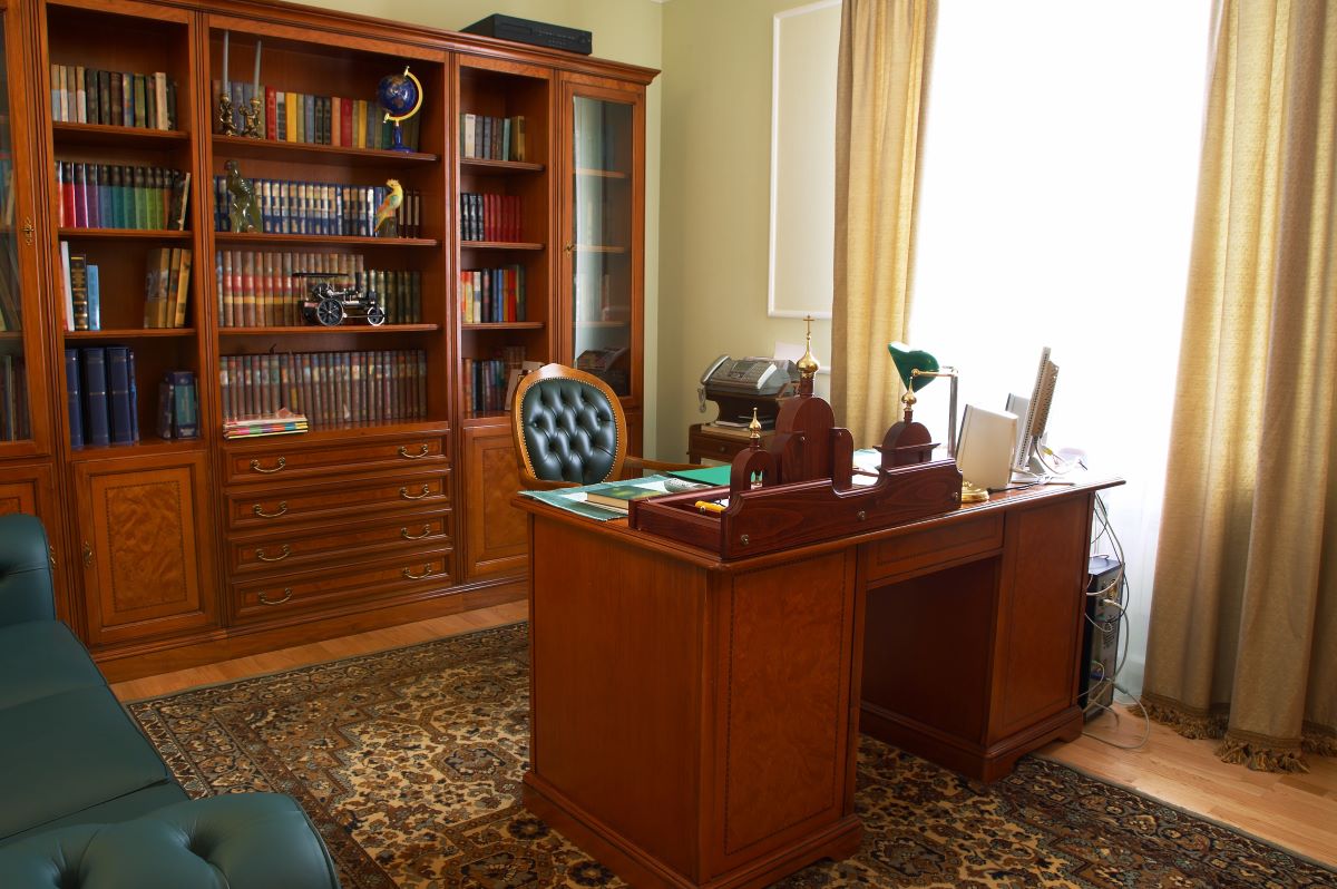 bookshelf behind desk office room