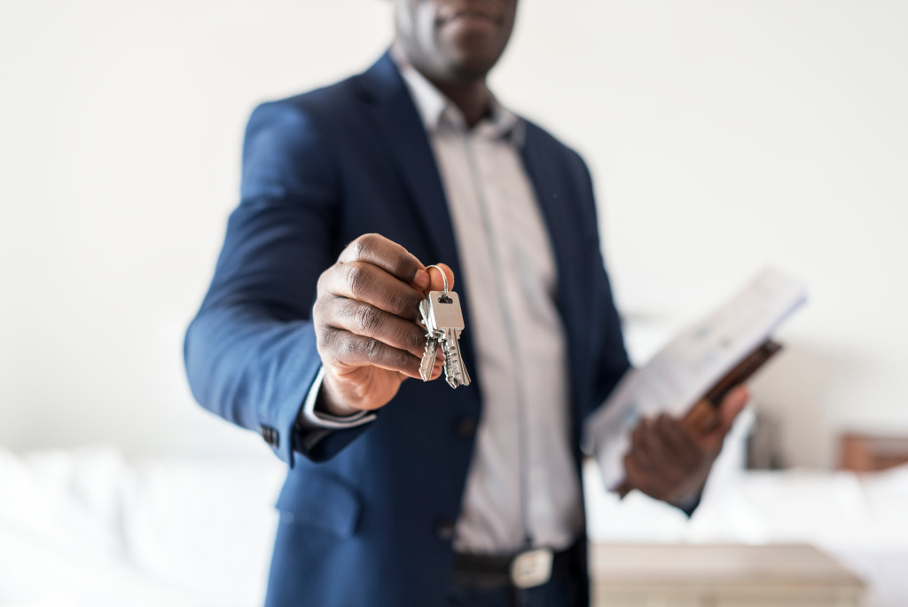 real estate agent handing over keys to house