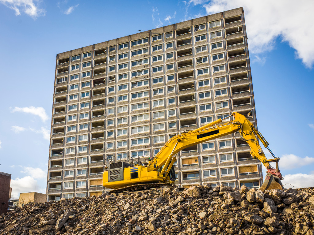 excavator in front of an unfinished building