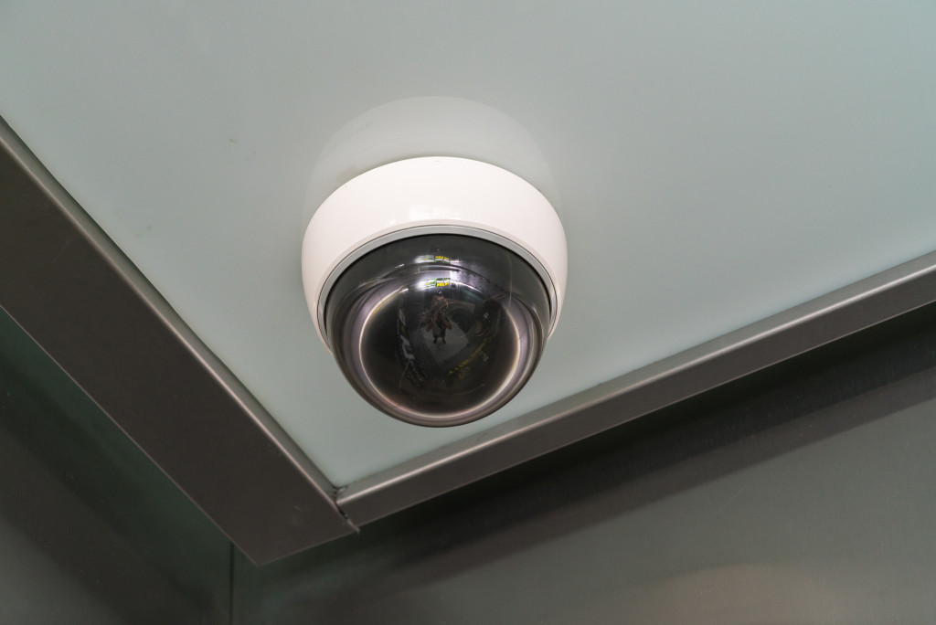 circular cctv situated on a corner of a room