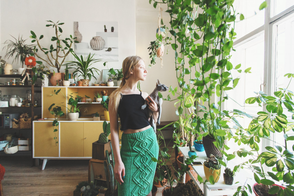 woman in her living room full of plants