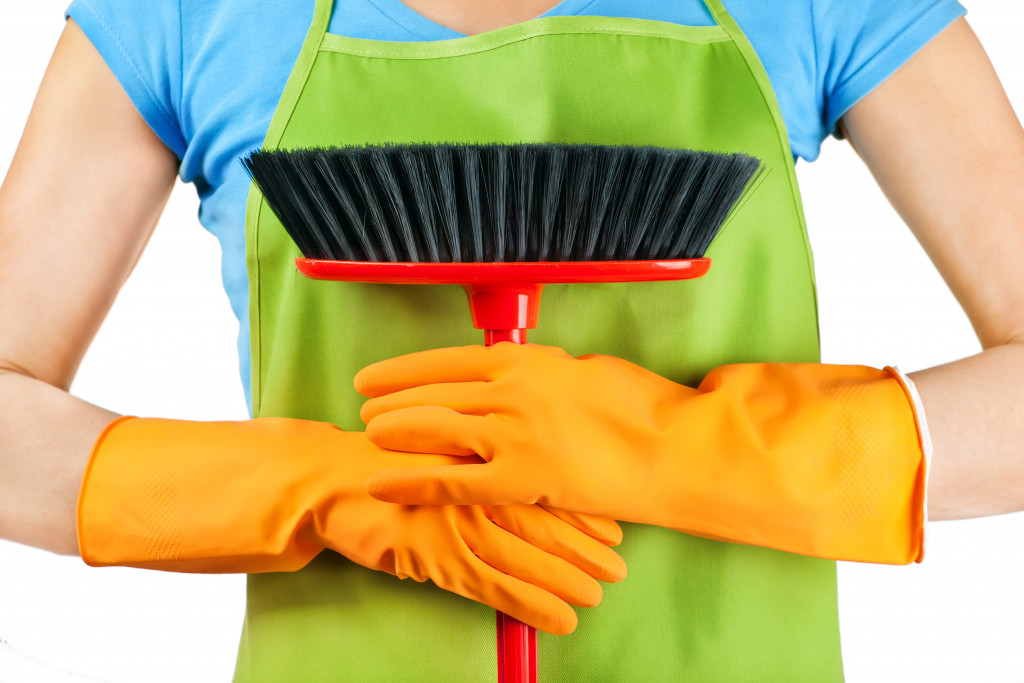 cleaning holding a broom