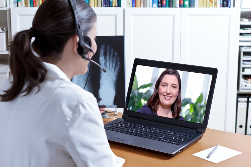 A doctor talking to a patient through a video conference software