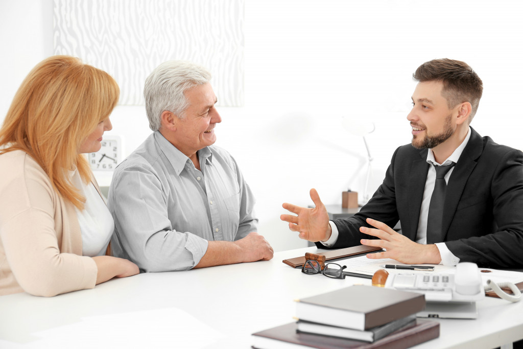 Real estate agent discusses with potential clients at the office