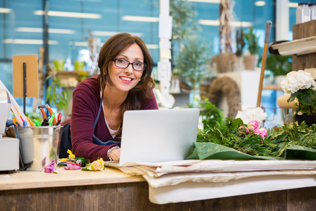 confident flower shop owner in her store