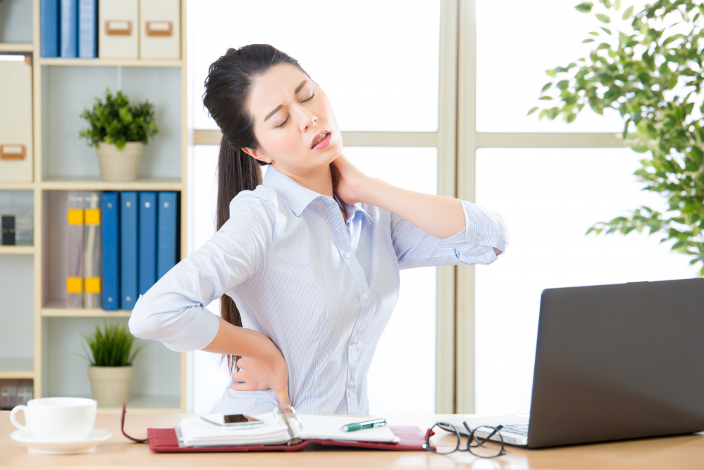 An employee experiencing back ache at work