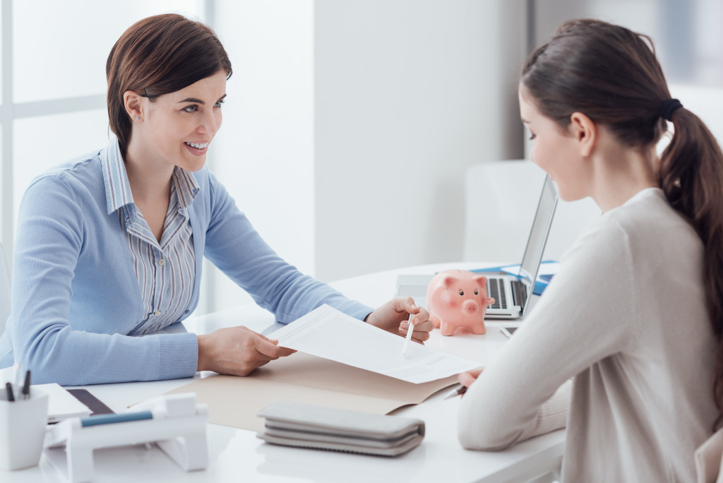 business consultant and customer meeting in the office the businesswoman is holding a contract
