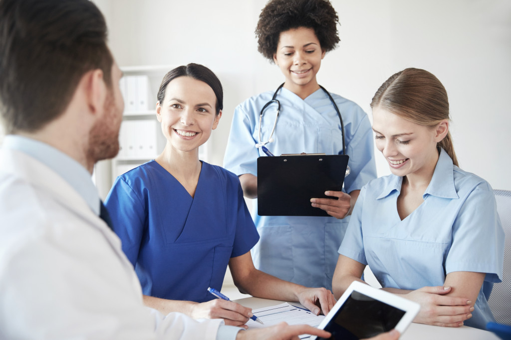 Medical providers talking during a meeting in a clinic