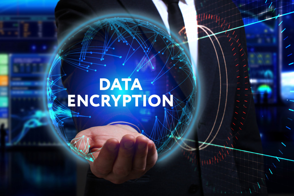 businessman holding a data encryption icon