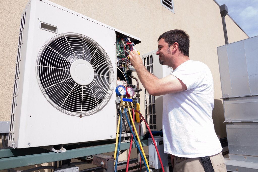 A man fixing an HVAC system