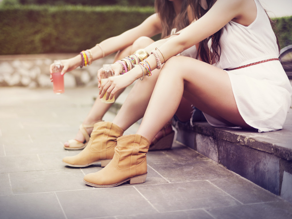Hippie-styled women sitting on a curb