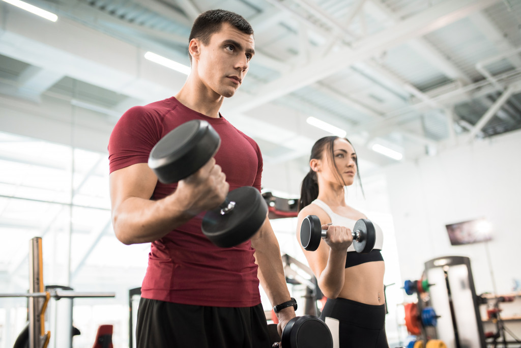 Two people working out at a gym