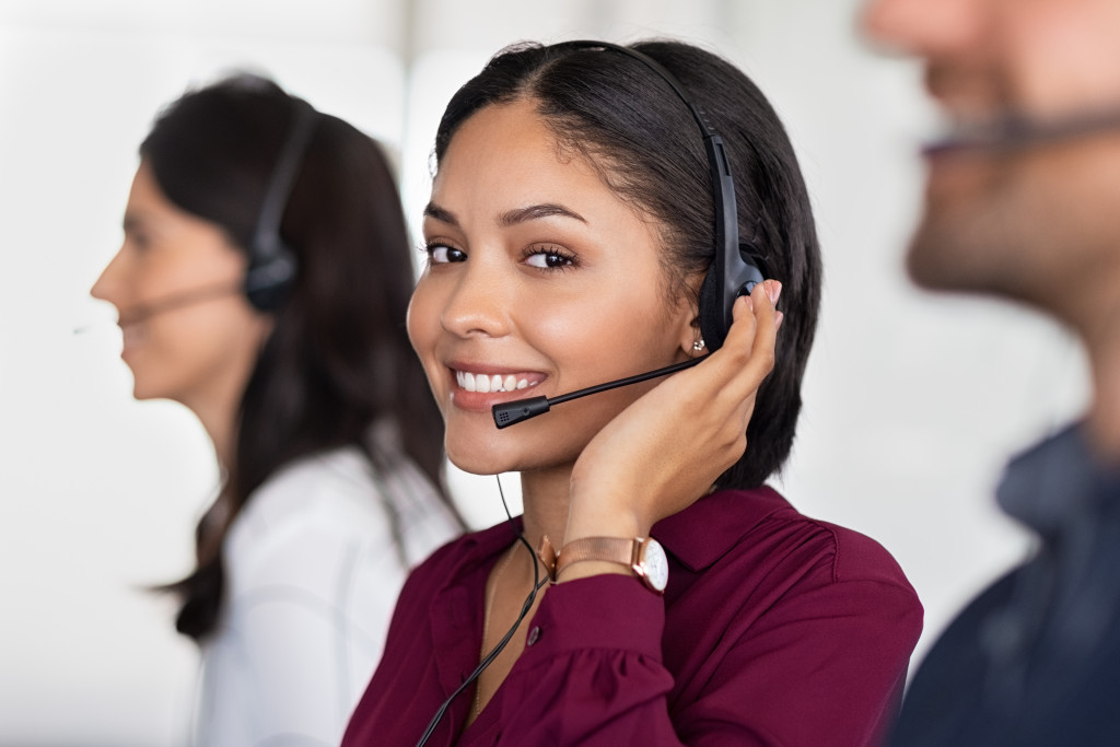 Customer support agent on a call using a headset.