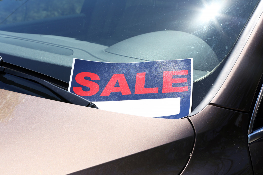 a sale sign on a secondhand car