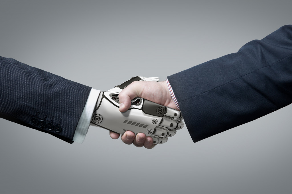 a businessman shaking hands of a robot