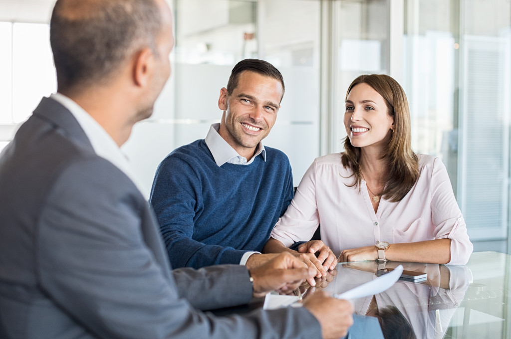 husband and wife talking to financial planner about their future