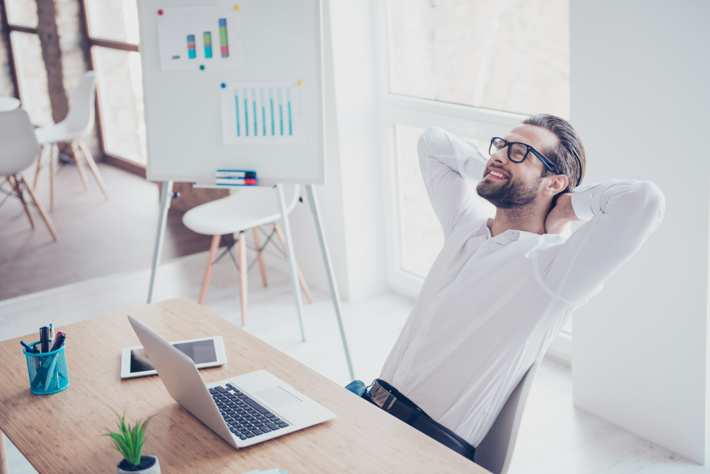 male entrepreneur smiling while resting for a while