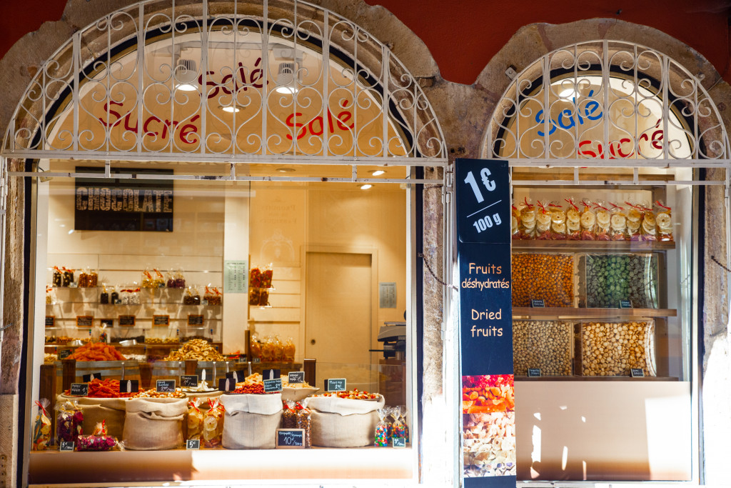 The window display of a confectionary store showing its products through the window.