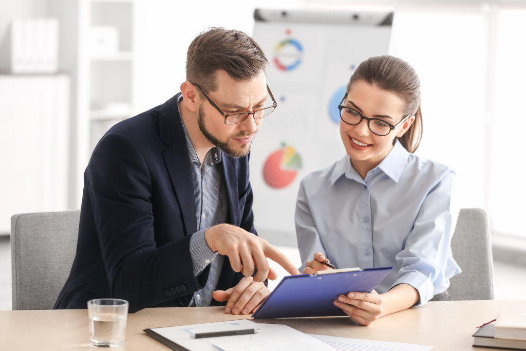 business owner discussing finances with a male employee