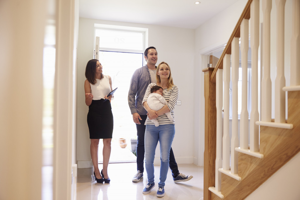 a couple looking at a house with an agent