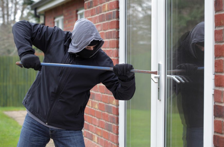 man breaking into a property