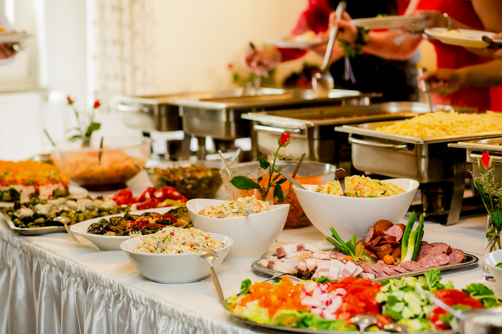 catering table with many food and decorations at a small event