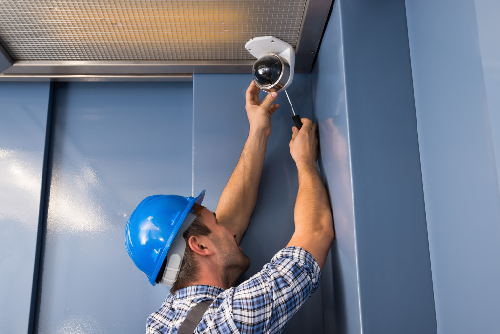 A worker installing a CCTV camera