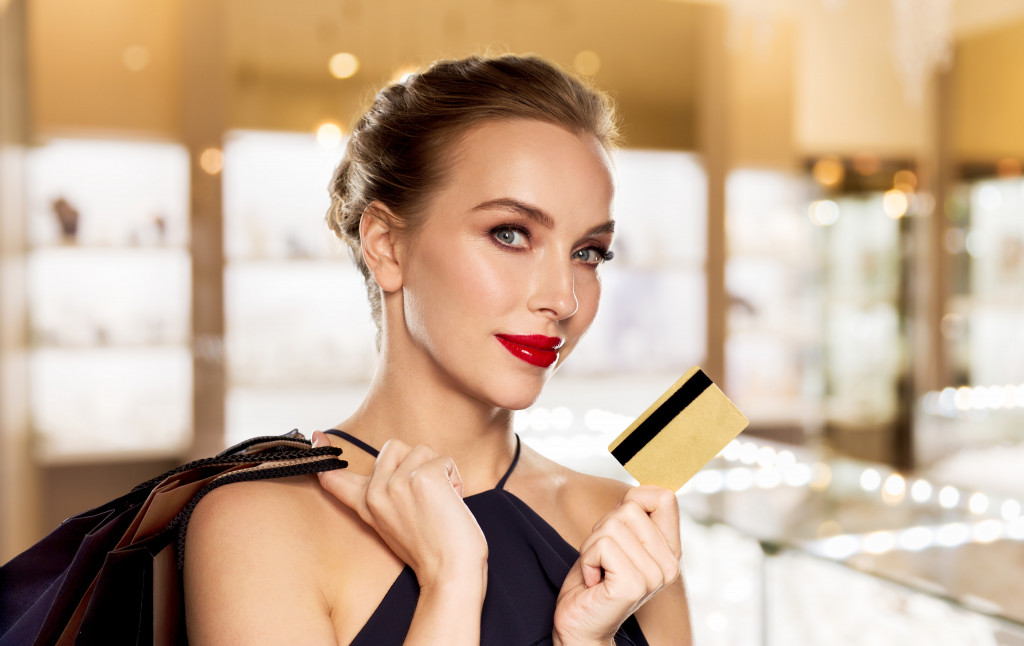 Elegant woman holding a credit card in a jewelry store