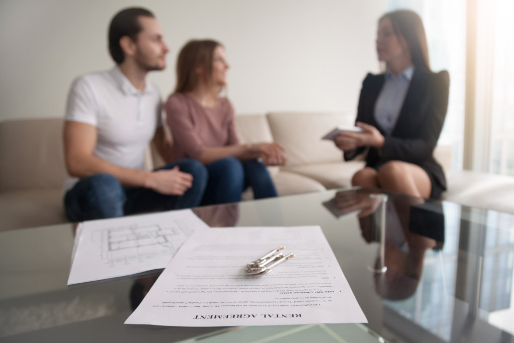 tenant and landlord talking in the living room couch