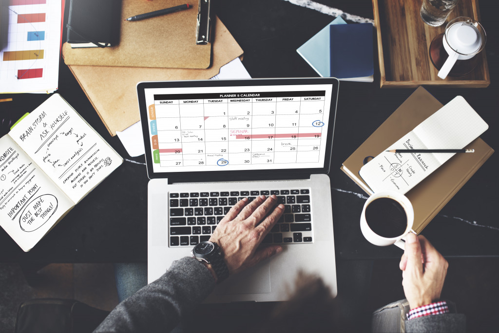 man checking a schedule calendar in his office