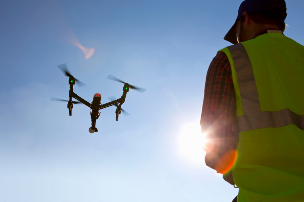 drone being controlled by construction worker