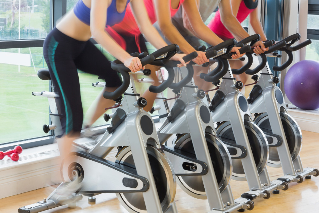 Women using stationary bikes