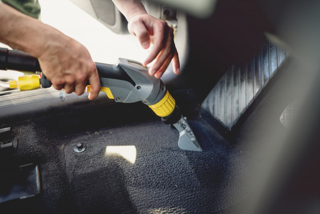 man cleaning a car and upholstery