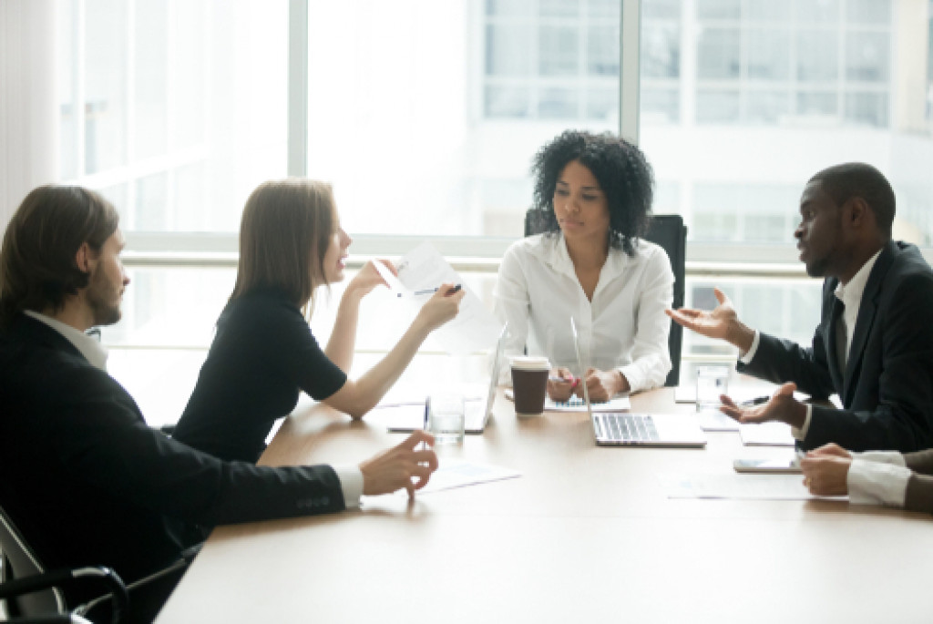 Business owner discussing business laws with lawyers.