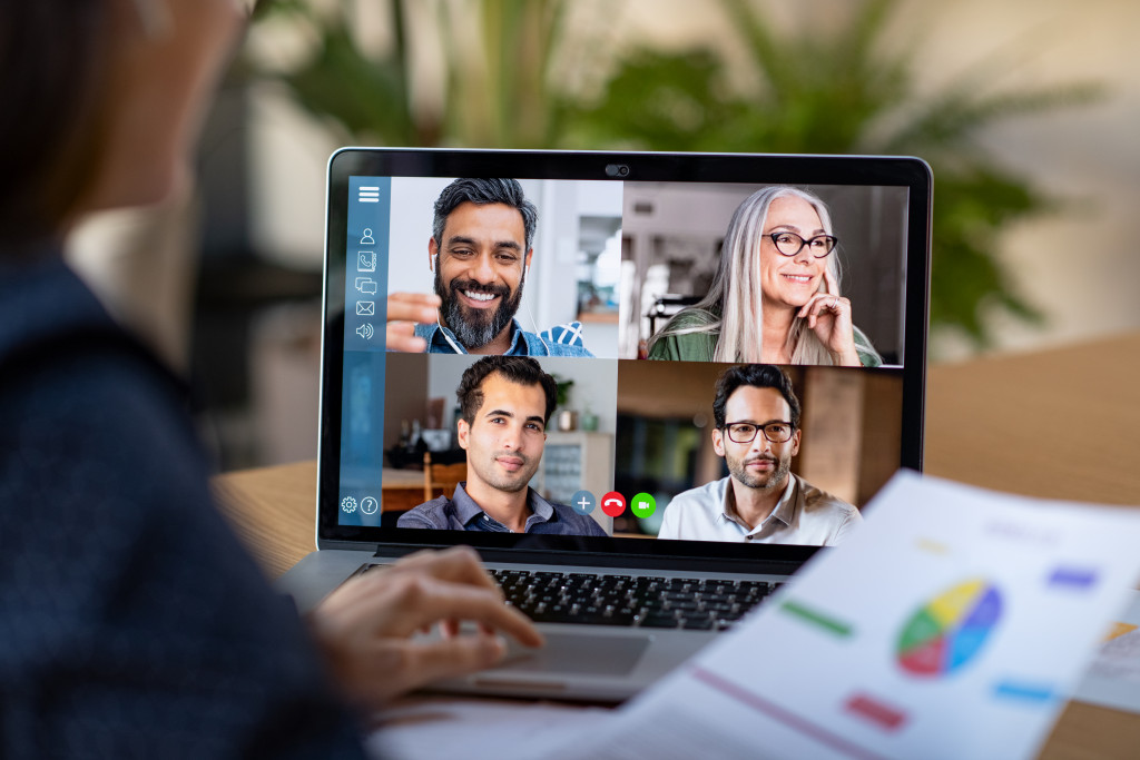 Home-based business owner meeting with other business owners using a laptop.