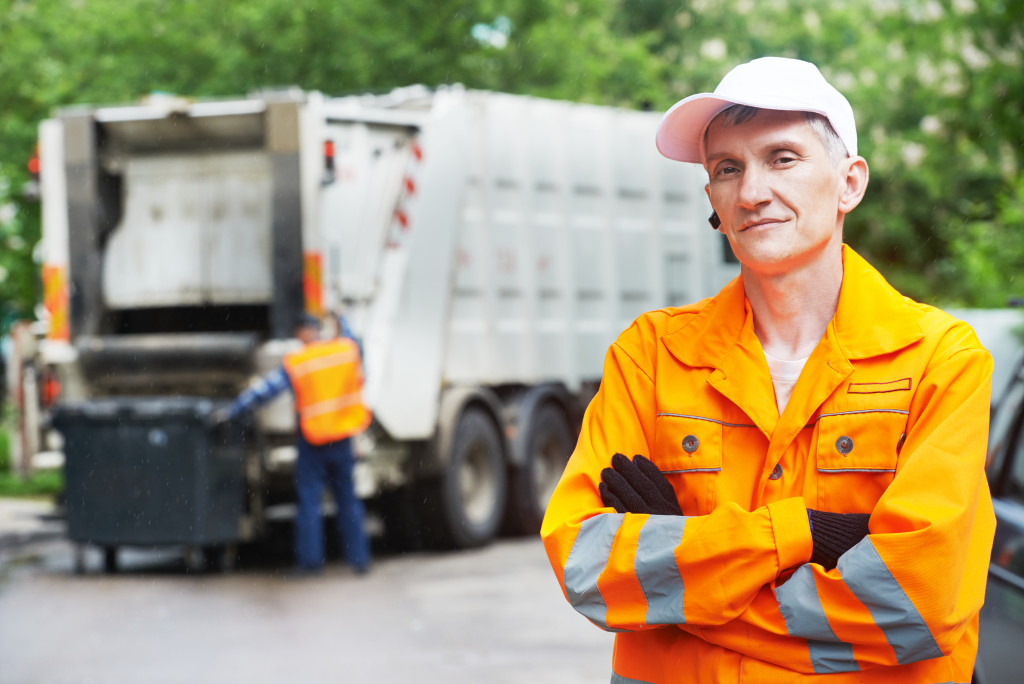 a garbage collector with his truck at the back