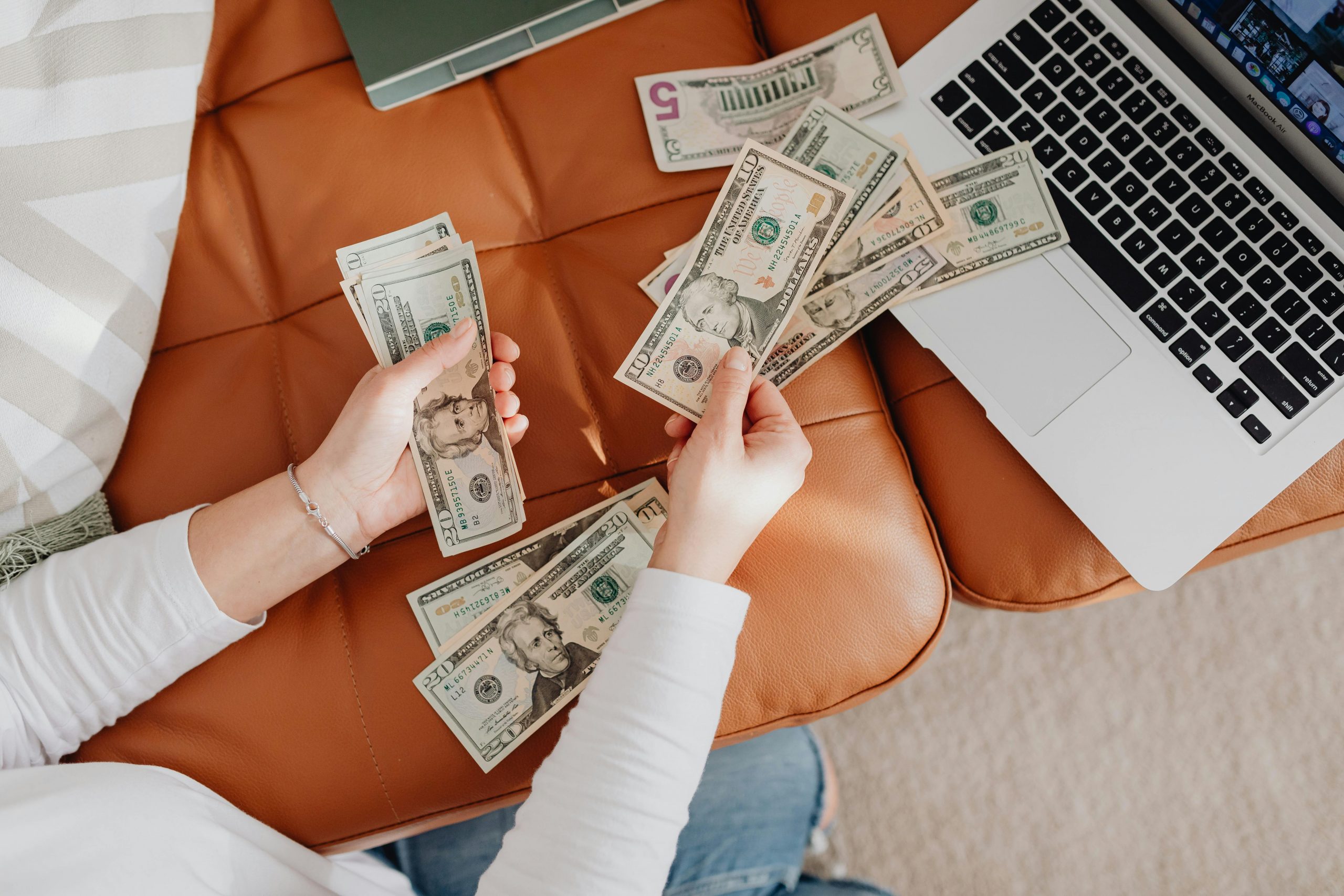woman counting dollar bills