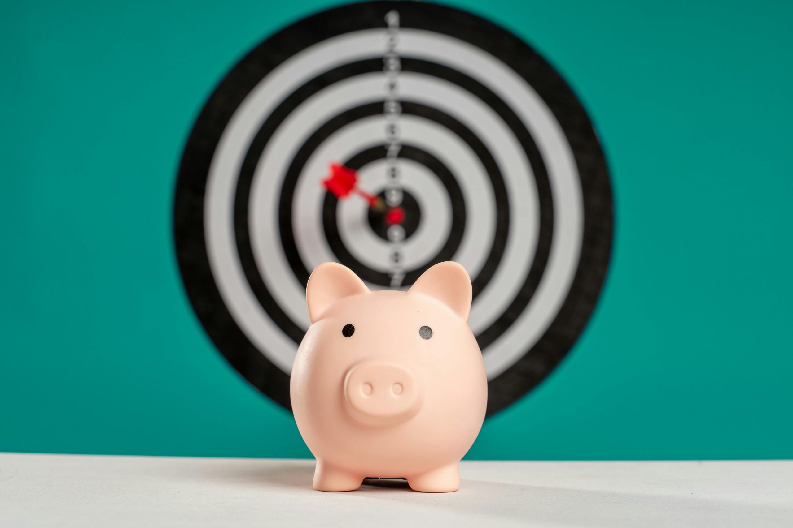 piggy bank with a bullseye dart board in the background